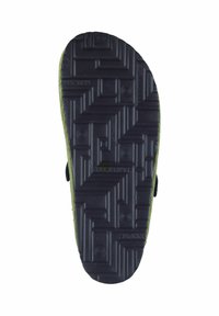 Black rubber sole with textured grip patterns, lined with green material at the edges. Features an open design for ventilation.