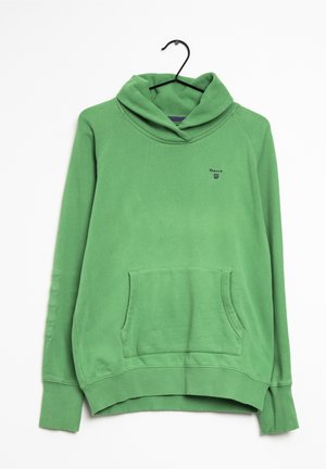 Sweat à capuche vert avec une poche devant, poignets et bas côtelés, petit logo sur la poitrine, suspendu sur un cintre noir sur fond blanc.