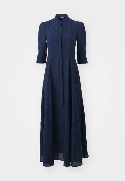 Navy blue linen dress with a high collar, button-front, and three-quarter sleeves. Flowing design with a full-length skirt and textured fabric.