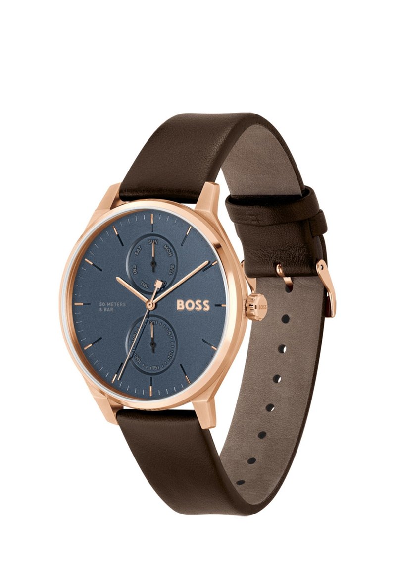 Montre pour homme avec un cadran bleu et un boîtier en acier inoxydable doré rose, bracelet en cuir marron et sous-cadrans de chronographe. Résistante à l'eau jusqu'à 50 mètres.
