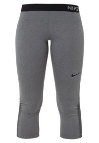 Leggings capri sportifs gris Nike avec ceinture noire et logo Nike swoosh noir sur la cuisse droite.