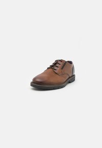 Brown leather lace-up shoe with perforated texture, rounded toe, and a black rubber sole. Features blue interior lining.