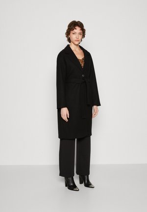 Claudia Sträter Reversible lammy coat met steekzakken • Zwart • de Bijenkorf