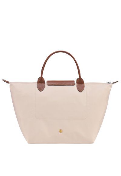 Beige tote bag made of nylon with brown leather handles and accents. Features a front pocket and gold-tone hardware. Zipper closure at top.