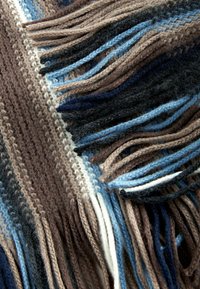 Knit wool scarf featuring alternating stripes of brown, blue, and black shades, with long, textured fringes at the edges.
