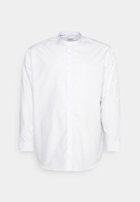 Vit långärmad skjorta i bomull. Har en mandarin-krage, framknäppning och manschetter med mjukt tyg.