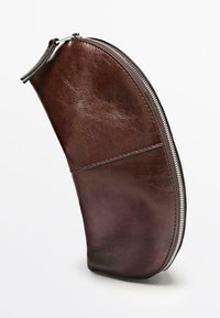 Brunt læder penalhus med en buet form, sølvfarvet lynlås og synlige syningsdetaljer. Overfladen virker glat med en let glans.