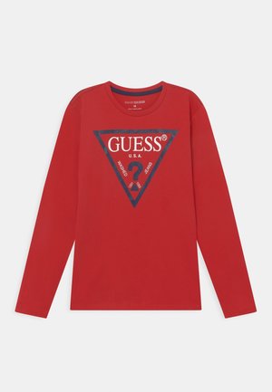 Camisa de manga larga roja con un triángulo azul marino y el texto en blanco "GUESS U.S.A." y un signo de interrogación impresos en el frente.