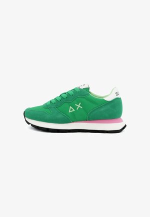 Green suede and fabric sneaker with white and pink sole, green laces, and white heel tab with black text on a white background.