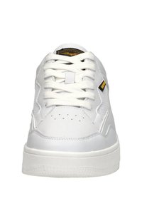 White sneakers with a smooth leather and mesh upper, round toe, and white laces. Features perforations on toe and a yellow logo detail.