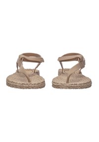 Beige espadrille sandals with woven jute soles, flat design, and minimalistic adjustable straps. Smooth texture with no visible patterns.