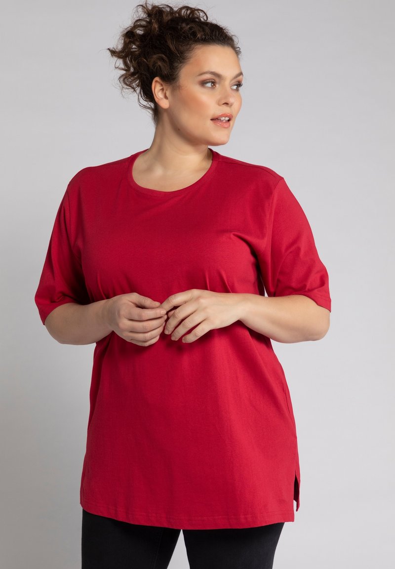T-shirt in cotone rosso con maniche corte, scollatura rotonda e spacchetti laterali. Texture morbida e vestibilità rilassata, adatta per un abbigliamento casual.