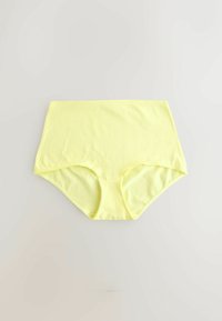 Sous-vêtement jaune taille haute sans coutures avec couverture complète, étalé à plat sur une surface gris clair.