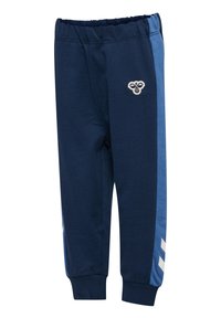 Marinblåa sweatpants i bomull, med ribbat midjeband, tvåfärgade blåa sidostråk och en logopatch nära höften.