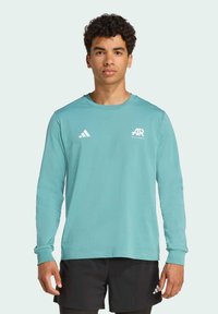 T-shirt de performance à manches longues, turquoise, avec des poignets côtelés et un logo Adidas blanc sur la poitrine et la manche, tissu lisse, coupe athlétique.