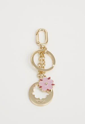 Gold-tone keychain with pink flower charm and circular tag engraved with "FURLA" on a white background.