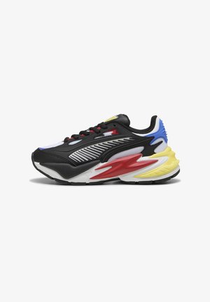 Black and white athletic sneaker with red, yellow, and blue accents, mesh panels, and a textured sole. Features bold, modern design elements.