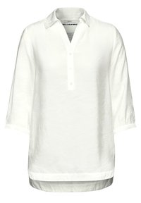 Camisa de lino blanca con cuello, mangas tres cuartos, cierre de botones y un dobladillo ligeramente curvado. Tejido texturizado con un corte relajado.