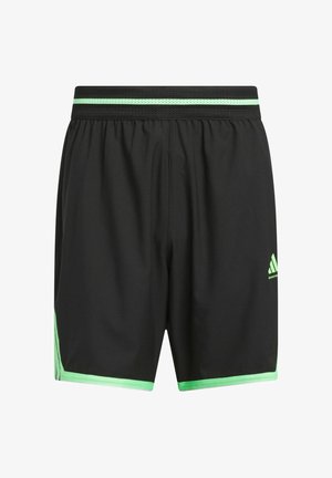 Crne atletske šortse s prozračnim pojasom, s zelenom prugom na vrhu i zelenim naglascima sa strane.