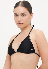 Black bikini top featuring a triangular design with scalloped edges, adjustable ties at the neck and back, and small logo detail.