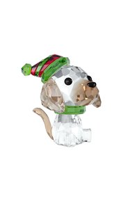 Kristallfigur av en hund med en beige och klar kropp, som bär en grön och röd randig hatt, detaljerad med svarta ögon och en svans.