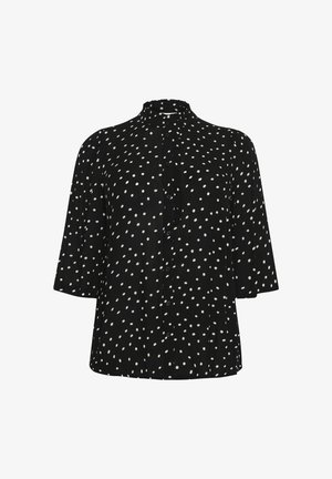 Maglietta nera con pois bianchi, scollatura tonda, maniche corte e chiusura con bottoni. Realizzata in un tessuto leggero con una vestibilità comoda.