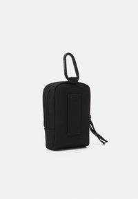 Pouch preto em nylon com fecho, apresentando uma superfície texturizada, equipado com um clipe de fixação e um cordão em laço para maior comodidade ao transporte.