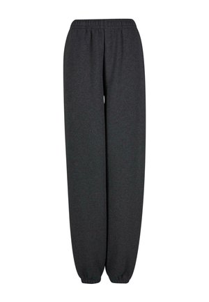 Süsinikhallad dressipüksid, mis on valmistatud pehmest kangast. Omavad elastset vöökohta ja kitsenevaid sääreotsi. Lihtne, ilma mustrite ja aktsentideta.