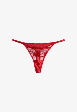 Red lingerie thong made from satin and sheer lace. Features floral embroidery on the back, with thin straps and a minimalist design.