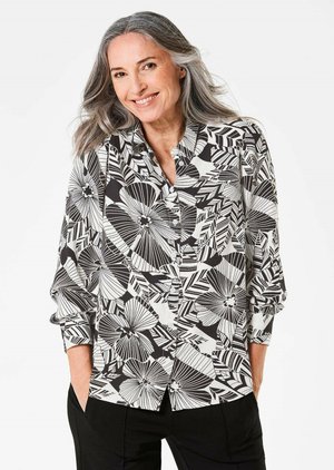 Langarmshirt van lichtgewicht stof in zwart en wit, met een bloemen- en geometrisch patroon en knopen aan de voorkant.