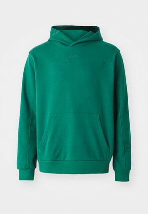 Grön hoodie i mjukt material, med en känguruficka, justerbar huva och ribbade mudd. Enkel design med minimal märkning.