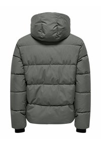 Padded hooded jacket in olive green. Features quilted design, elastic cuffs, and a soft textured fabric. Back view showcases the hood and seams.