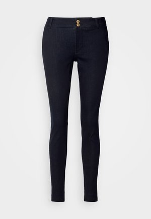 Dark blue denim trousers with a slim fit, two front pockets, two decorative buttons at the waistband, and smooth texture.
