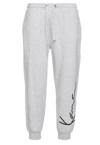 Gray sweatpants made of soft fabric, featuring an elastic waistband with drawstrings, ribbed cuffs, and a black abstract design on one leg.