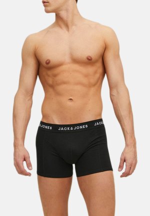 Boxer di cotone neri con un morbido elastico che presenta il logo "JACK & JONES" in bianco, design aderente, texture liscia e lunghezza fino a metà coscia.