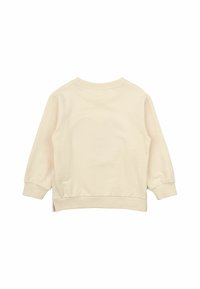 Krämfärgad sweatshirt med rund halsringning, långa ärmar och ribbade kanter. Sidoklyftor i fållen ger extra detalj åt designen.