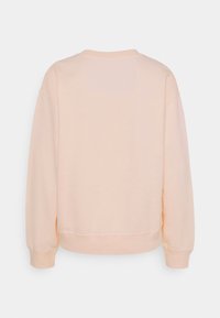 Felpa color pesco chiaro con maniche lunghe, polsini e orlo a coste, mostrata da dietro su uno sfondo bianco semplice.
