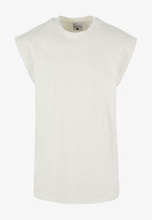 T-shirt sans manches surdimensionné en coton écru. Caractéristiques d'un col rond et d'un logo brodé subtil en fil assorti. Texture douce.