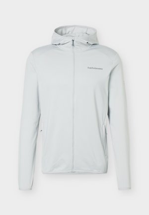 Ανοιχτό γκρι μπουφάν με κουκούλα και πλήρη φερμουάρ, μακριά μανίκια, δύο πλαϊνές τσέπες με φερμουάρ και μικρό λογότυπο "Peak Performance" στο αριστερό στήθος.