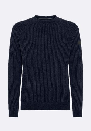 Maglione a costine blu navy con maniche lunghe, scollo rotondo e una piccola toppa nera sulla parte superiore della manica sinistra.
