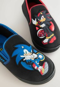 Black slip-on shoes with blue and red trim featuring Sonic the Hedgehog and Shadow the Hedgehog cartoon characters on the toes.