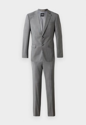 Gray suit with a textured finish, featuring a fitted jacket with two buttons and straight-leg trousers. Label visible inside the jacket.