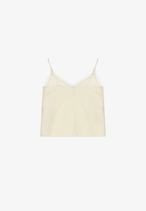 Top smanicato color crema con spalline sottili e rifinitura in pizzo lungo la scollatura e i lati, mostrato su sfondo bianco.