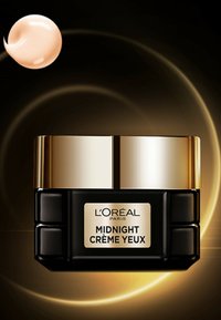 Pot noir avec des accents dorés, étiqueté "MIDNIGHT CRÈME YEUX." Produit crémeux beige au-dessus, texture lisse, design moderne.