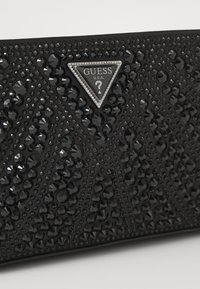 Guess BEAUVOIR MINI TOP ZIP BAG - Bolso de mano - black