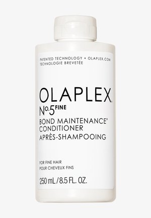 Bouteille en plastique blanc avec un bouchon à vis. Le texte noir inclut "OLAPLEX No.5 Après-shampooing de maintenance des liaisons fines" et les détails du produit. 250 mL.