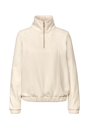 Jasnobeżowy polarowy pulower z wysokim kołnierzem, zamkiem na pół długości i elastycznym obszyciem na dole oraz przy mankietach. Posiada subtelne przeszycia na panelach.