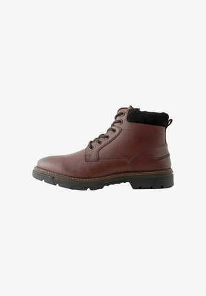 Brown leather ankle boot with black textile collar, round toe, six metal eyelets, and a textured rubber sole for grip.