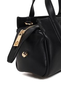Black leather handbag with gold zipper, gold round metal feet, and double handles on a white background.