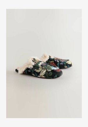 Floral-patterned slip-on slippers with a black woven fabric, white faux fur trim, and a rounded toe shape. The sole is flat and textured.